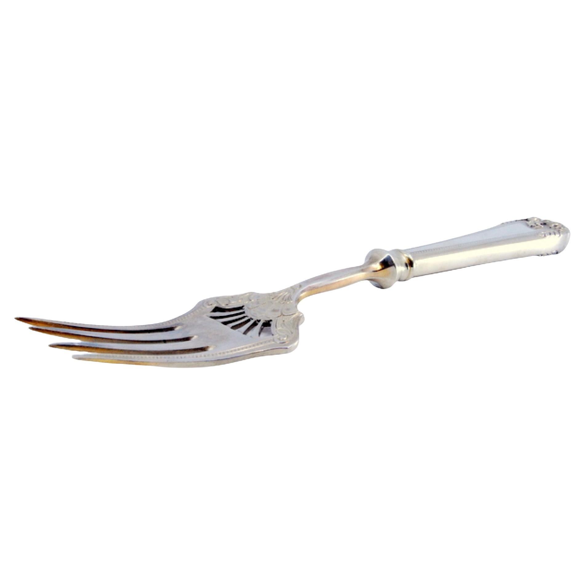 Silver fish serving fork w/ 4 engraved prongs, friezes
a shell on the handle