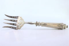 Silver fish serving fork w/ 4 engraved tines & grooves along the raised handle