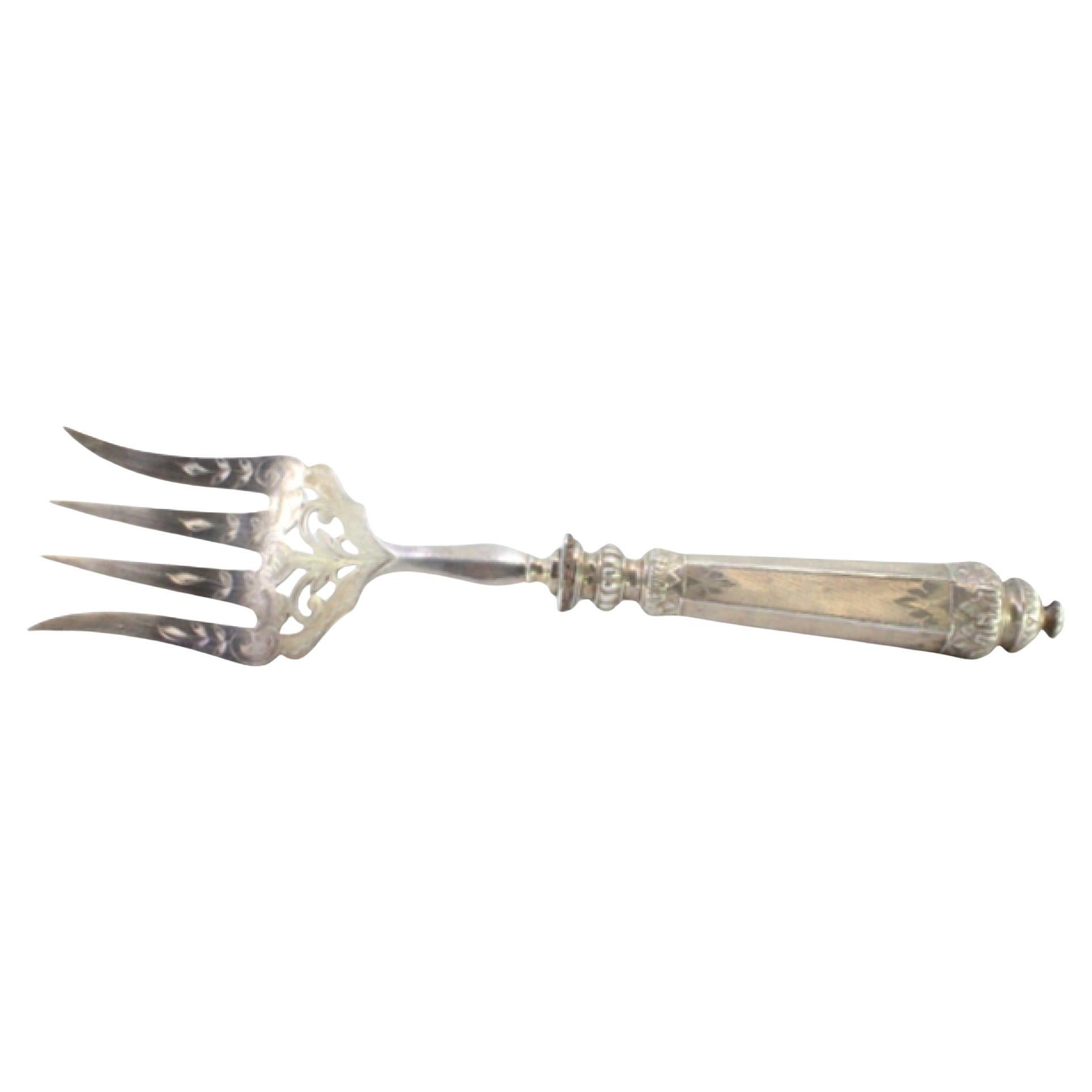 Silver fish serving fork w/ 4 engraved tines
grooves along the raised handle