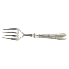 Silver fish serving fork w/ engravings surrounding a monogram card on the handle