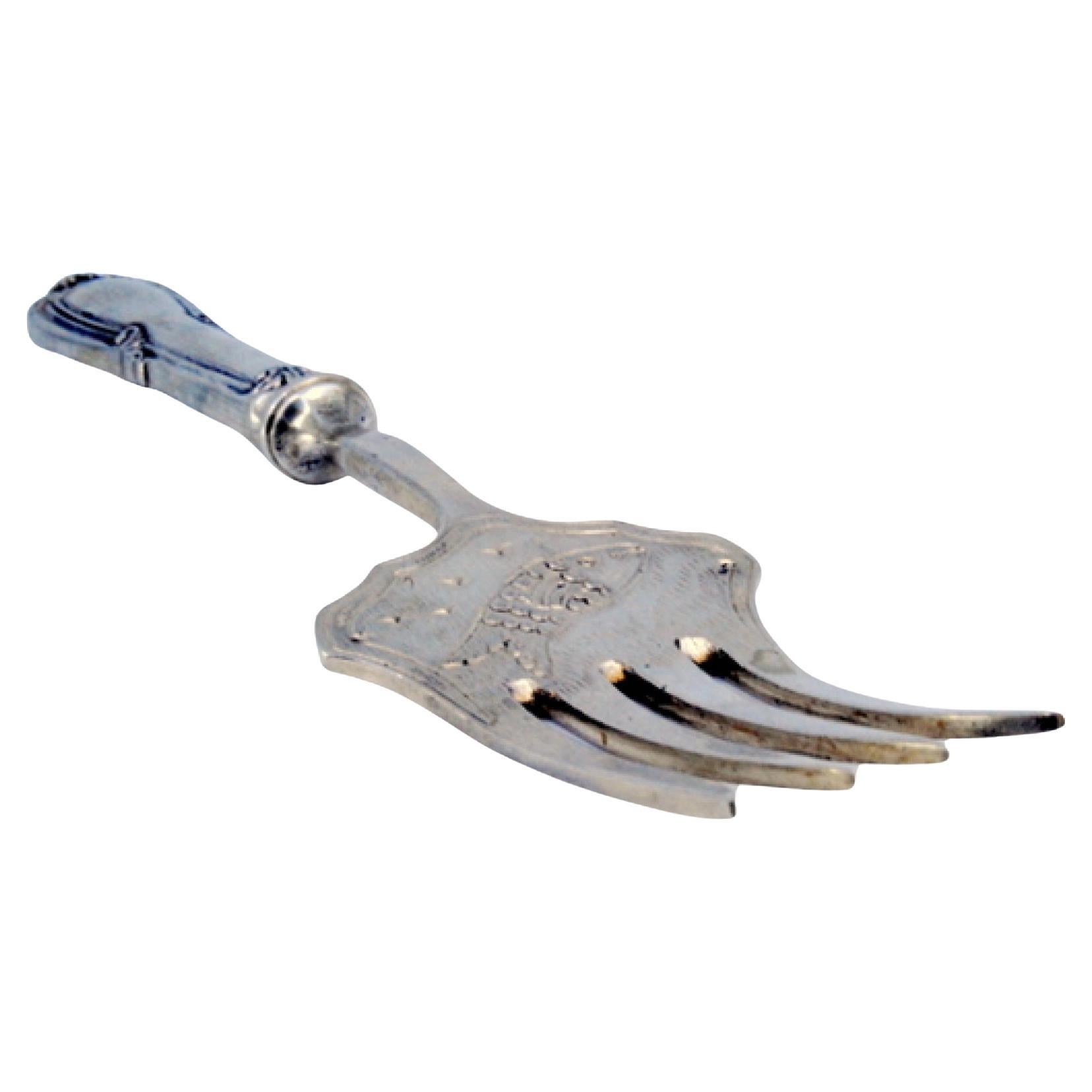 Silver fish serving fork w/ four prongs 
engraved handle w/ friezes 
scrolls For Sale