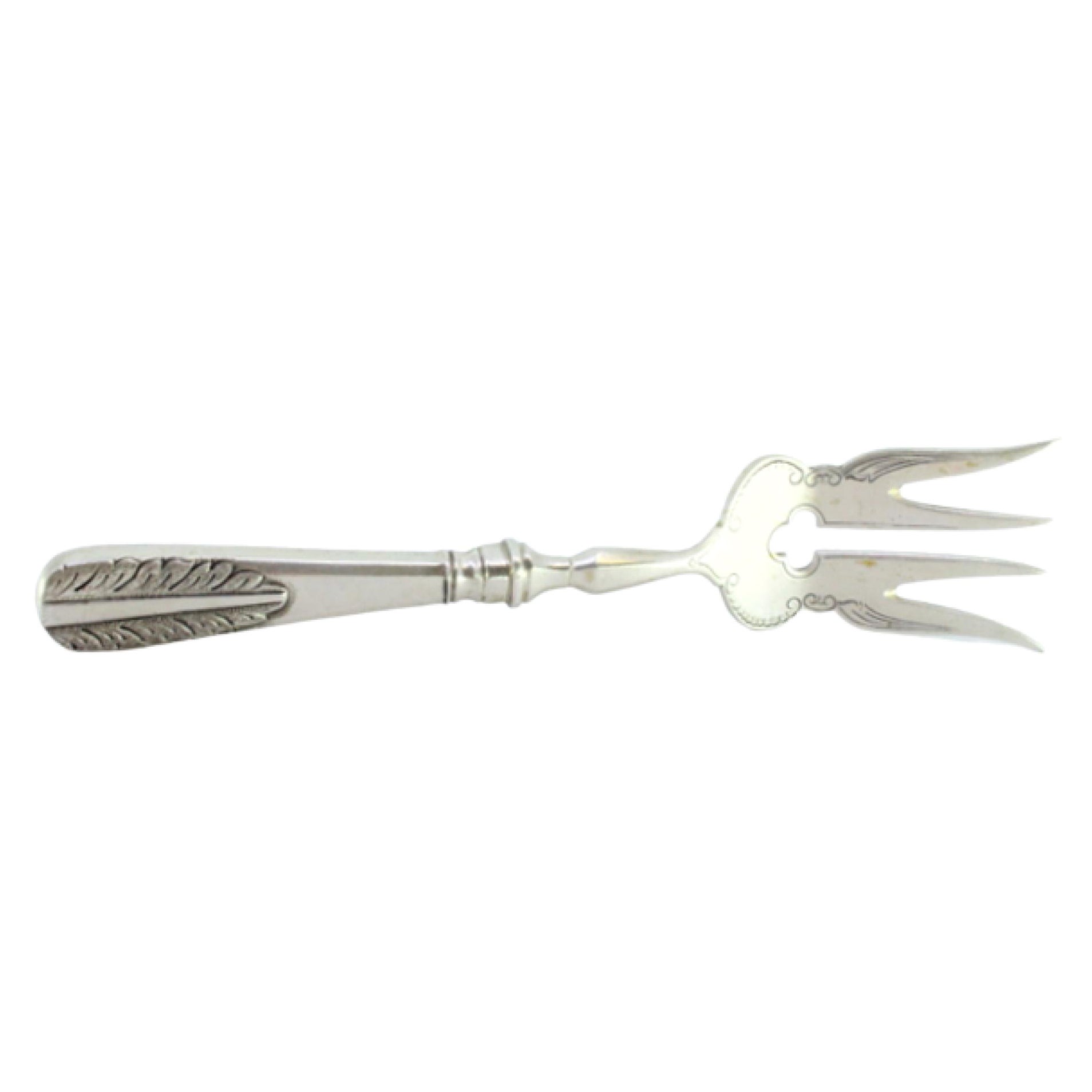 Silver fish serving fork with floral motifs in relief on the handle
