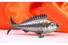Silver fish-shaped toothpick holder with raised scales on fins