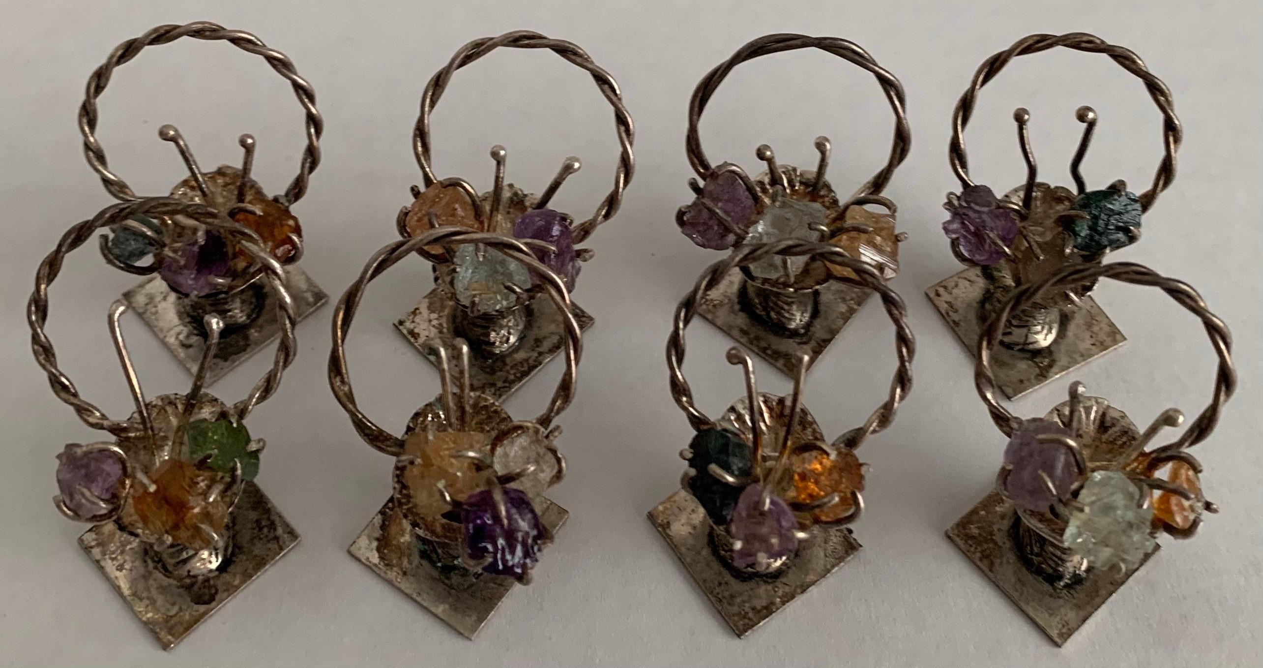 1950s Brazilian 900 silver basket place card holders. Each holder features a “bouquet” of semi precious stones. Twisted round silver holder. Each holder is stamped 900 on the underside. Overall unpolished patina.