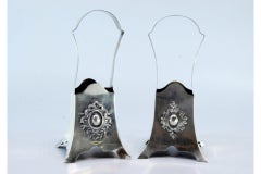 Silver flower boxes/baskets with reliefs in the center and set on four feet