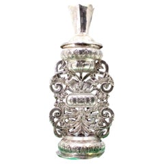 Silver flower pot with bird and lion reliefs on round pedestal