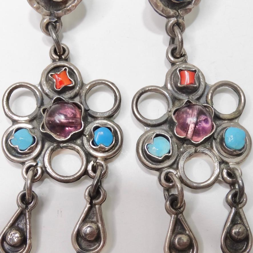 These 1970 flower motif dangle earrings are so versatile and fun! Sterling silver is sculpted alongside turquoise and, orange and purple stones into an intricate flower with dangling drops as the finishing touch. The colors of the stones in this are
