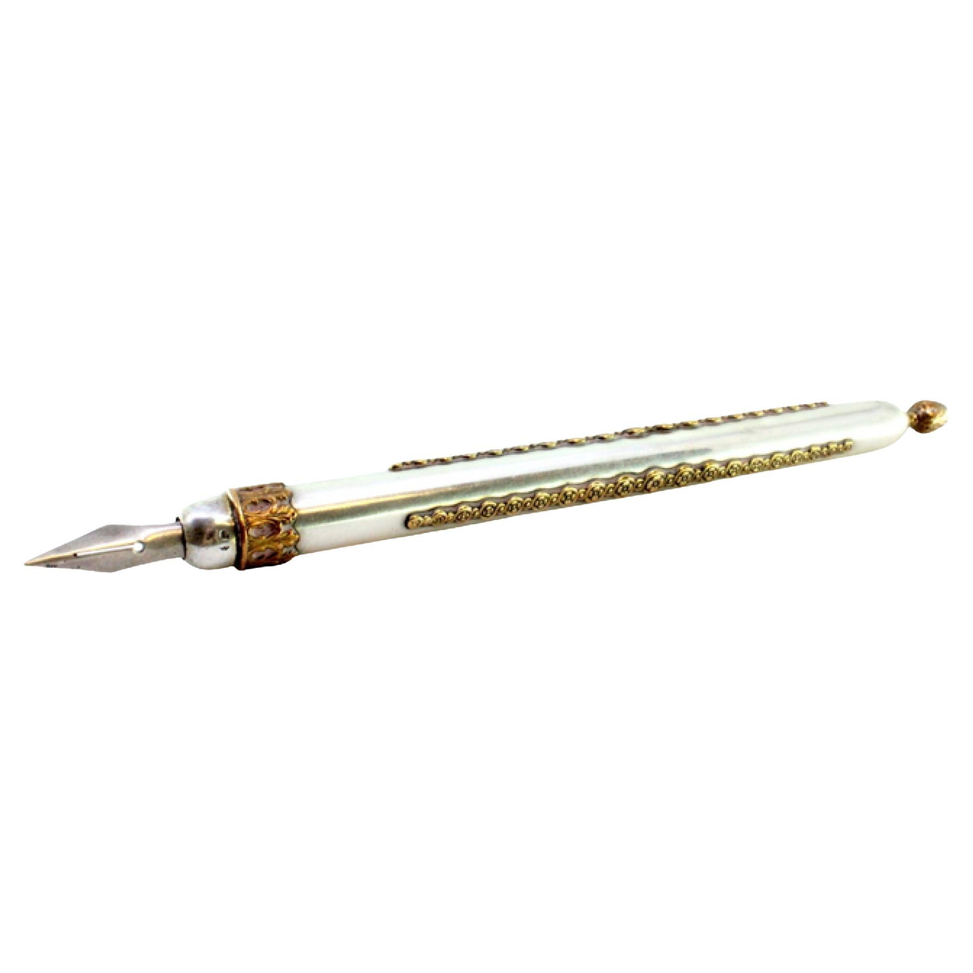 Silver fountain pen with triple gold trim and pine cone-shaped pommel