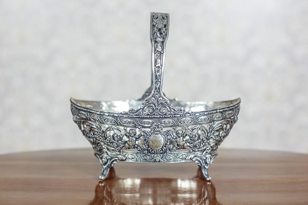 We present you a silver basket with an insert of cobalt glass, which is designed for fruits or flowers.

Silver weight: 408.700 g.
Silver hallmark: 0.830.

This item is hallmarked with a Swedish silver hallmark circa 1928.
The whole has a