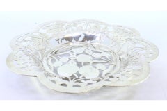 Silver fruit bowl cut into the shape of fruit and resting on four openwork feet