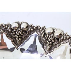 Silver fruit bowl cut into the shape of fruit with reliefs on the outside