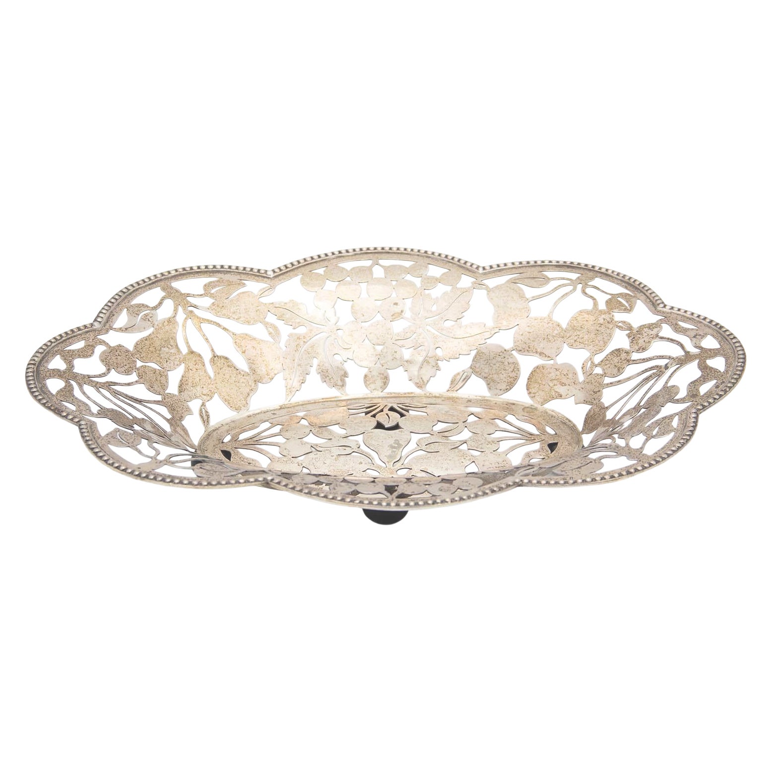 Silver fruit bowl cut out with fruit and leaf shapes