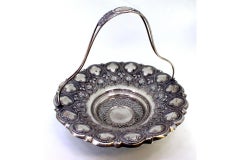 Silver fruit bowl w/ embossed floral motifs, hinged handle w/ monogram insert