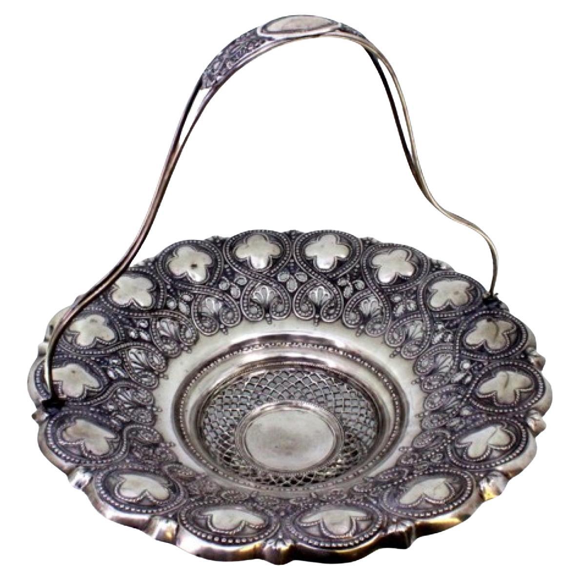 Silver fruit bowl w/ embossed floral motifs, hinged handle w/ monogram insert