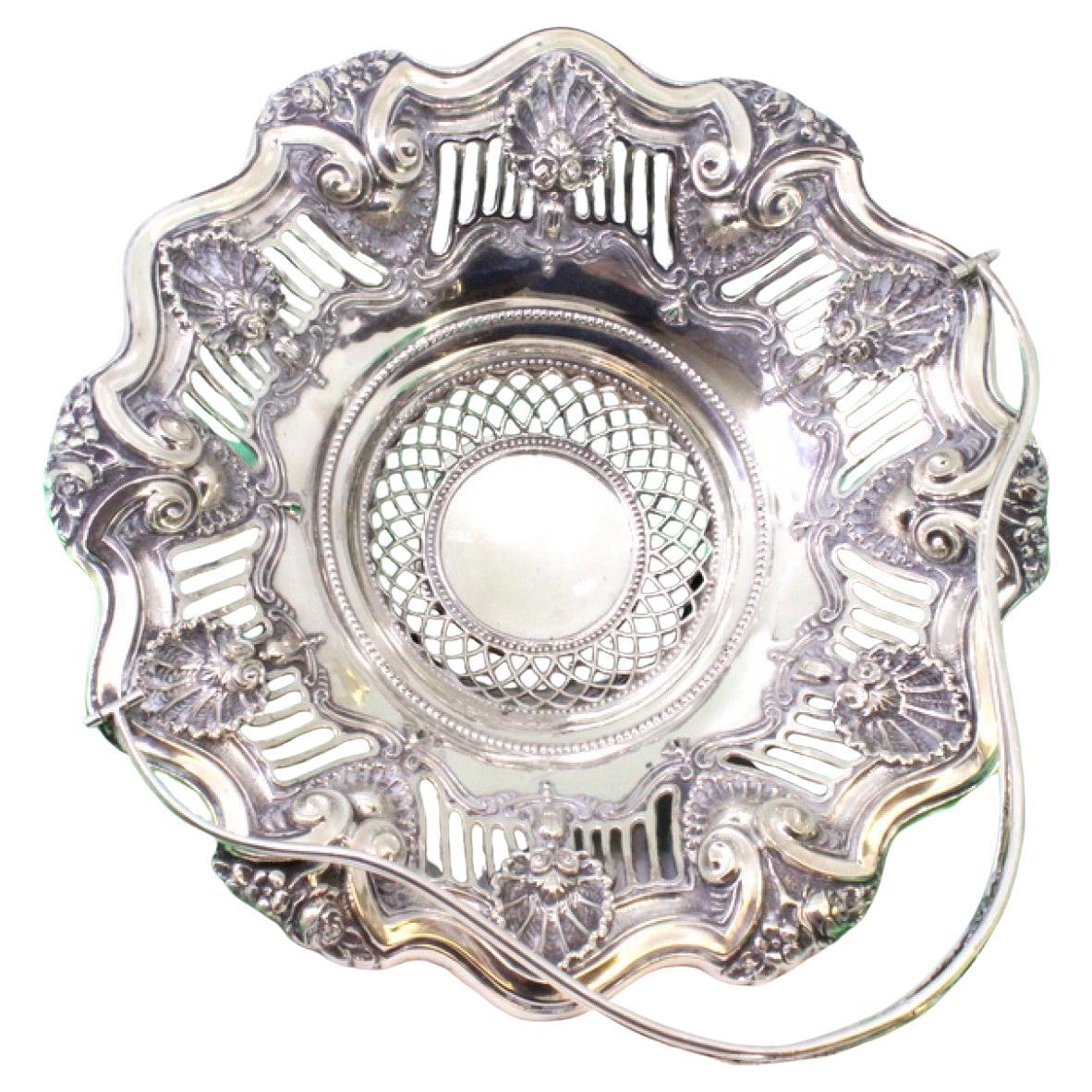 Silver fruit bowl w/ shell cutouts
reliefs, double handle w/ monogram card