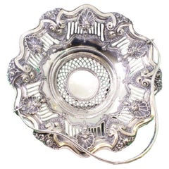 Silver fruit bowl w/ shell cutouts
reliefs, double handle w/ monogram card