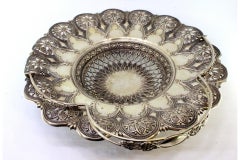 Silver fruit bowl with cutouts, floral embossing and hinged monogram handle