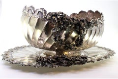 Silver fruit bowl with floral embossing, shell friezes and spiral body