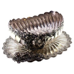 Silver fruit bowl with floral embossing, shell friezes and spiral body
