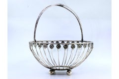 Silver fruit bowl with floral motifs, monogram handle and ball feet