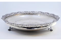 Silver fruit bowl with rack, floral engraving and three cut-out feet