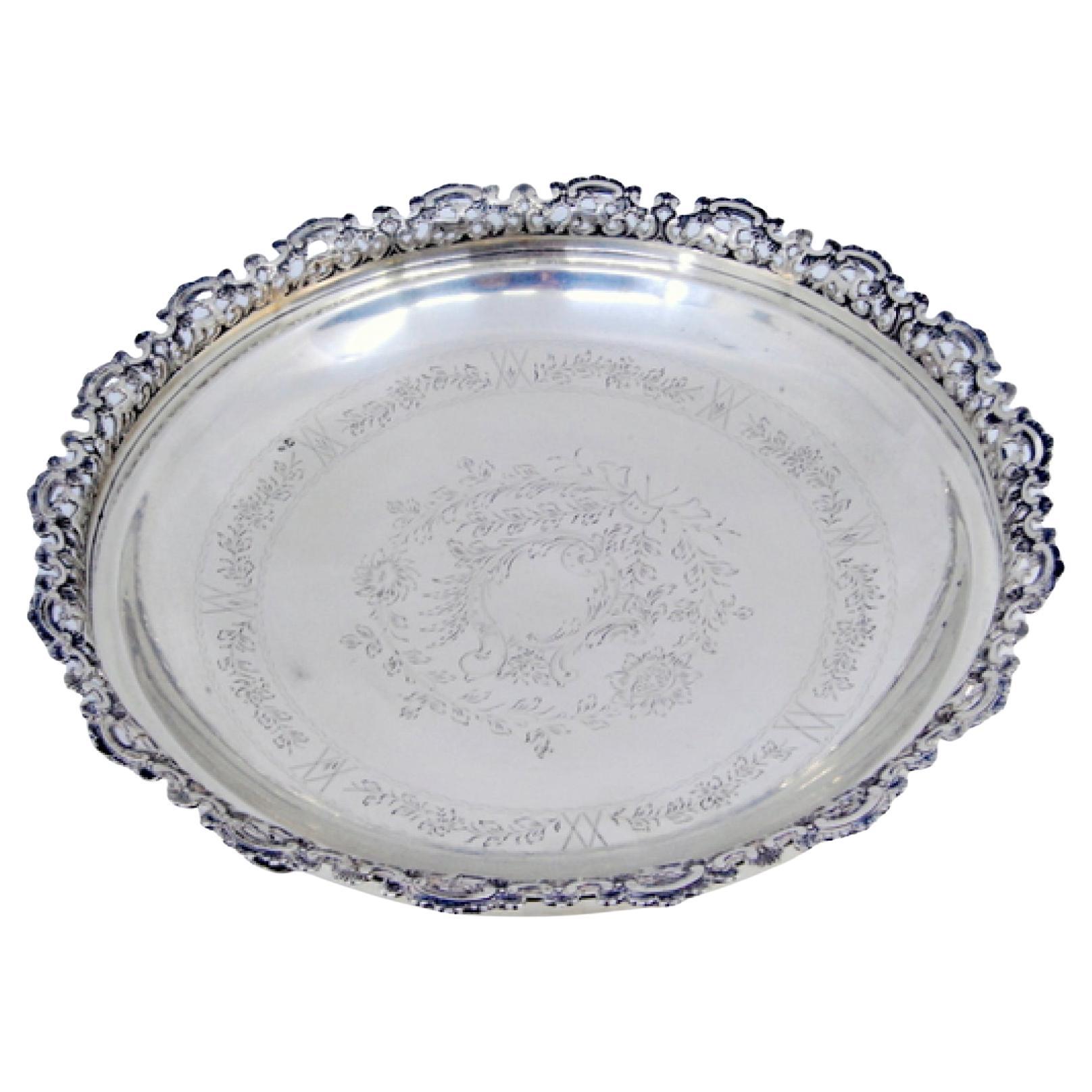 Silver fruit bowl with rack, floral engraving and three cut-out feet