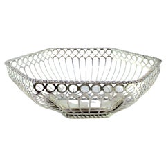Silver fruit centerpiece with grid and hexagonal scroll frieze