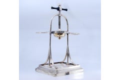 Silver fruit juicer with two side supports with floral motifs and a wooden base