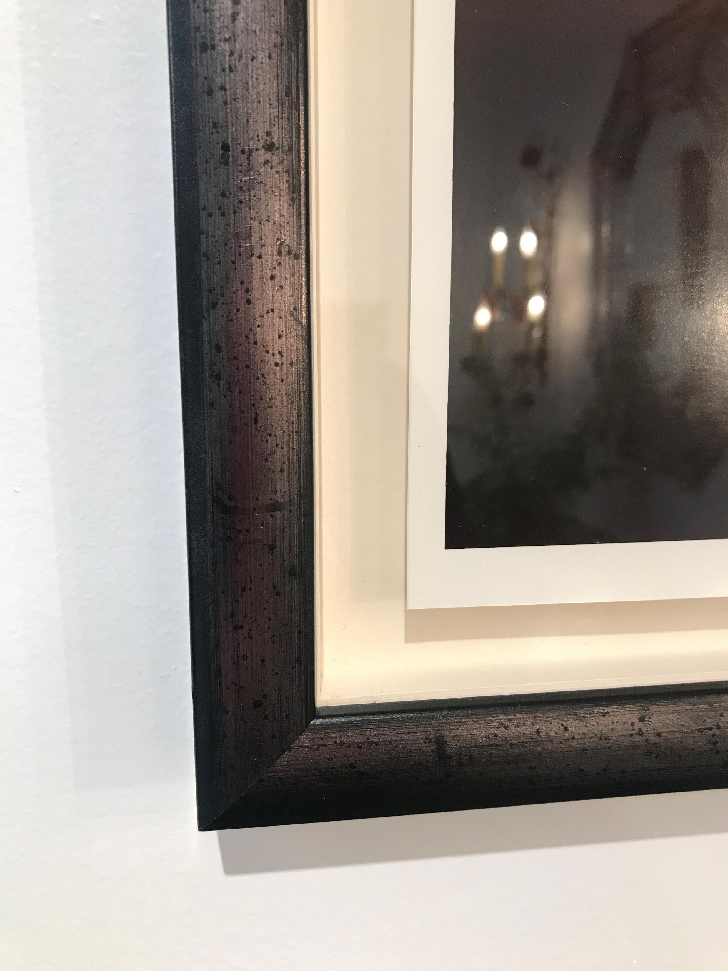 Beautiful silver gelatin photograph of red cliffs with a full moon and driftwood. Placed on a silver mat with hand painted frame, signed lower right.