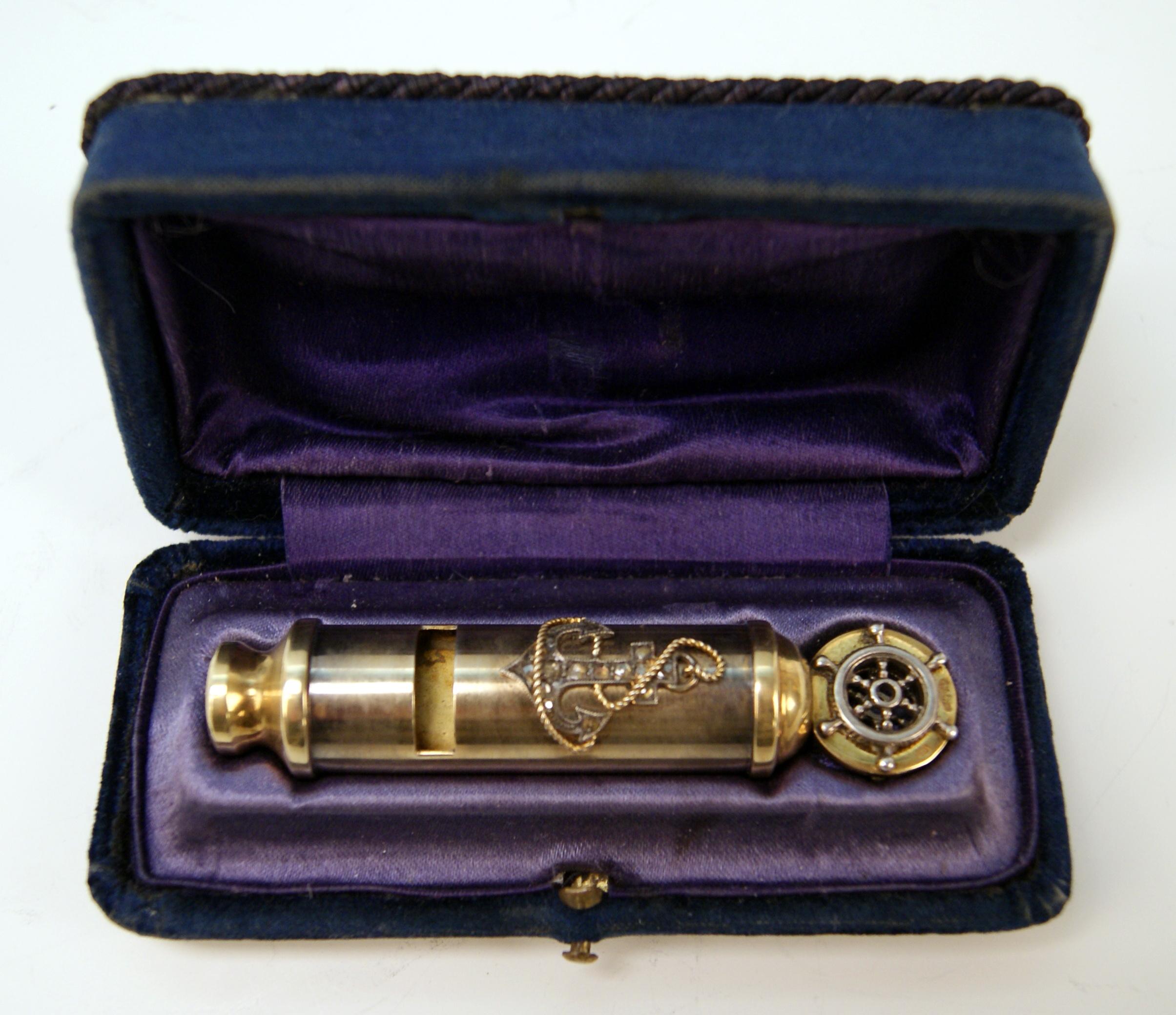 Whistle made of gilded silver
The decoration consists of diamonds covering an anchor.
Additionally there is a small handle shaped as a steering wheel.
Original casket existing!

Hallmarked:
-- ASSAYER'S MARK:
 IVAN SERGEYEVICH LEBEDKIN /
