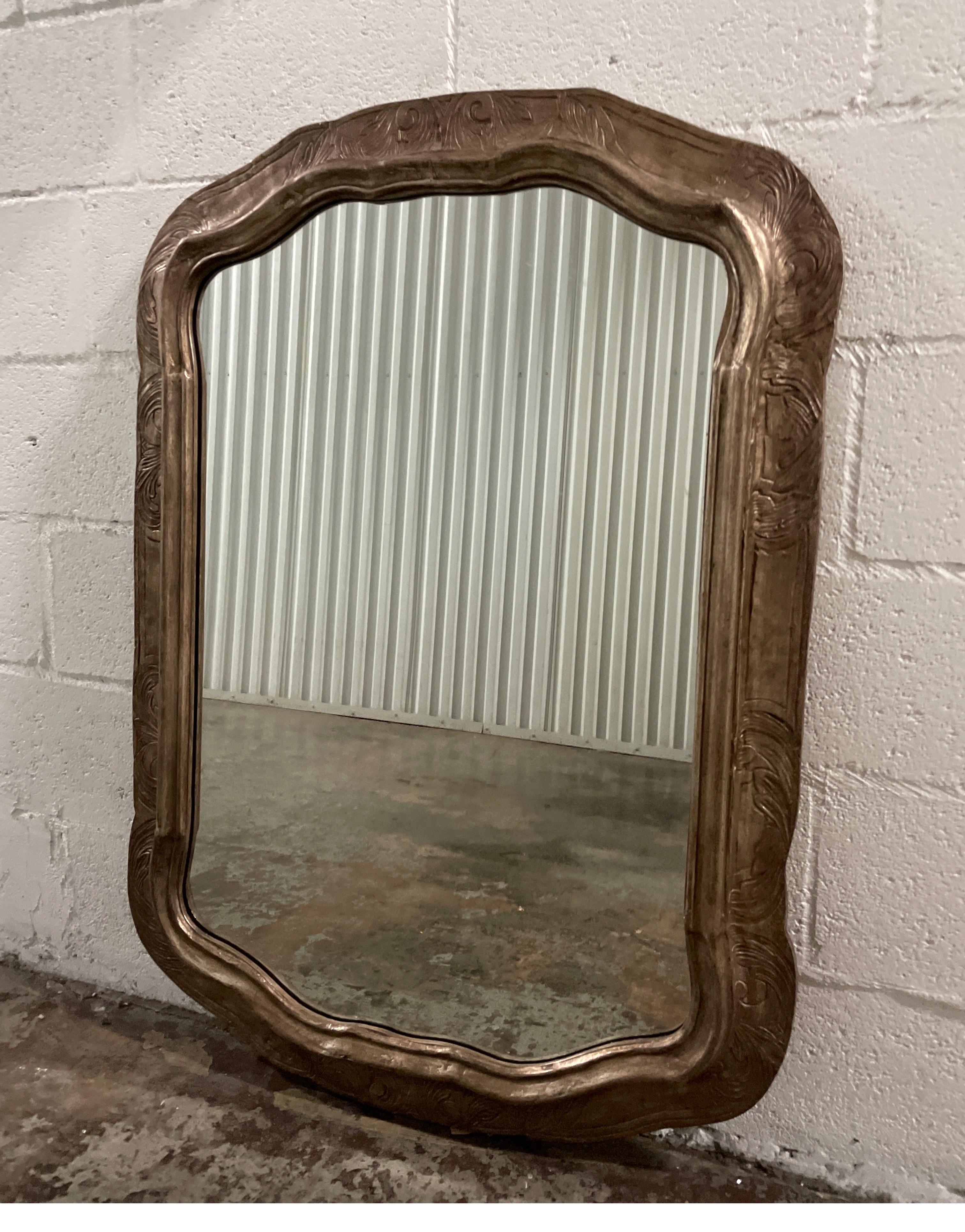 Carved & silver gilded embossed scalloped mirror by Friedman Brothers for Decorative Arts.