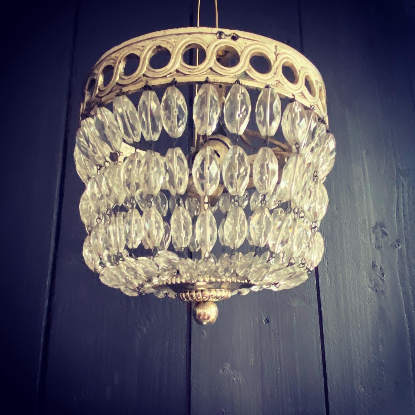 Silver gilt baguette chandelier of small proportions, circa 1920. Attractive Grecian scroll decoration with pretty droplets which terminate into an attractive gadrooned finial. Glass is all present and complete. Fitted with two bulb holders. Would