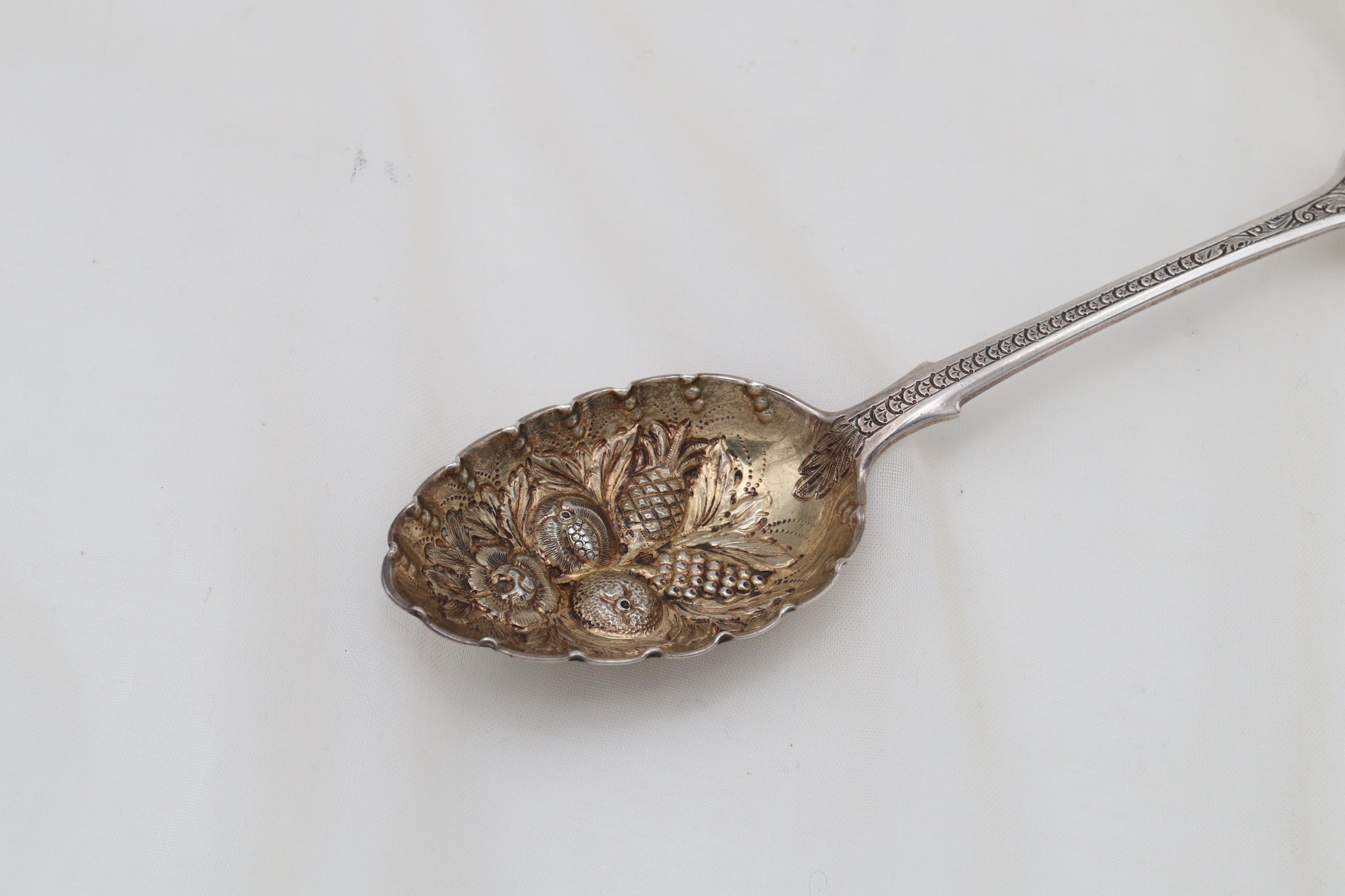 This lovely sterling silver berry spoon was made by James and Josiah Williams of Exeter and it carries the hallmarkmark for 1861. The ornate decoration leads from the fiddle pattern top of the handle down to the embossed bowl which features, amongst