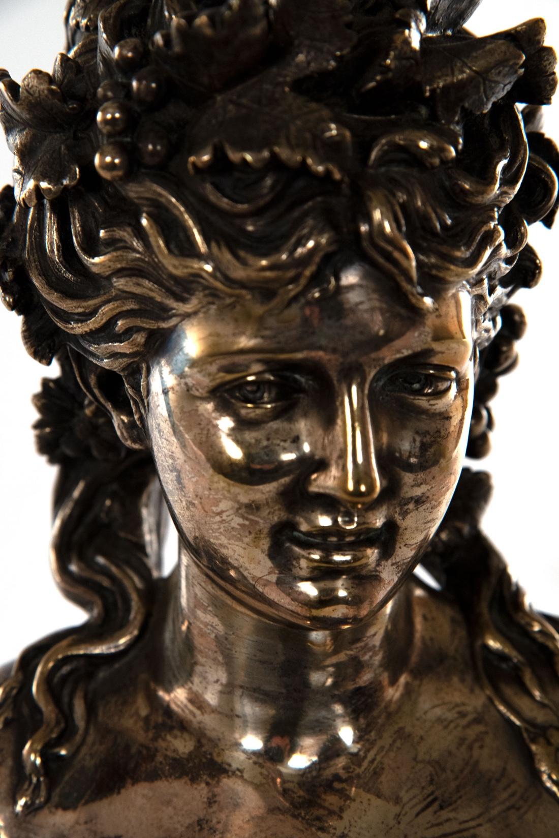 Jean Louis Gregoire (French, 1840-1890). A fine silvered bronze bust of a young woman. The youthful maiden with her hair adorned with grapes and vines, her bosom tied with a ribbon and floral pin, raised on an outswept shaped rectangular plinth,