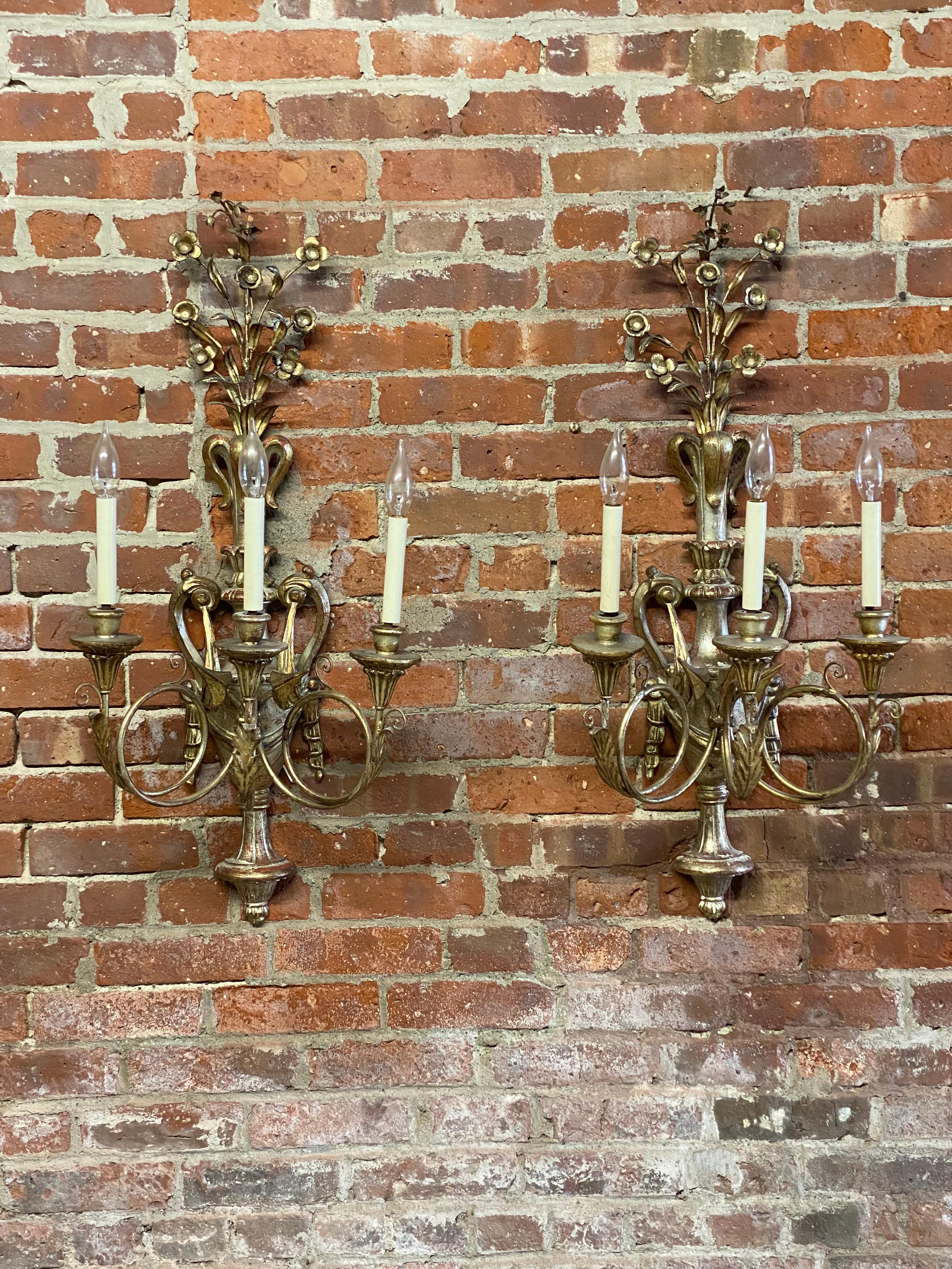 A sumptuous pair of Italian Baroque style silver gilt metal and carved wood scrolled and foliate wall sconces. Imported from Italy circa 1950-60 by the family I purchased these from. The pair has an amazing presence and has just the amount of patina