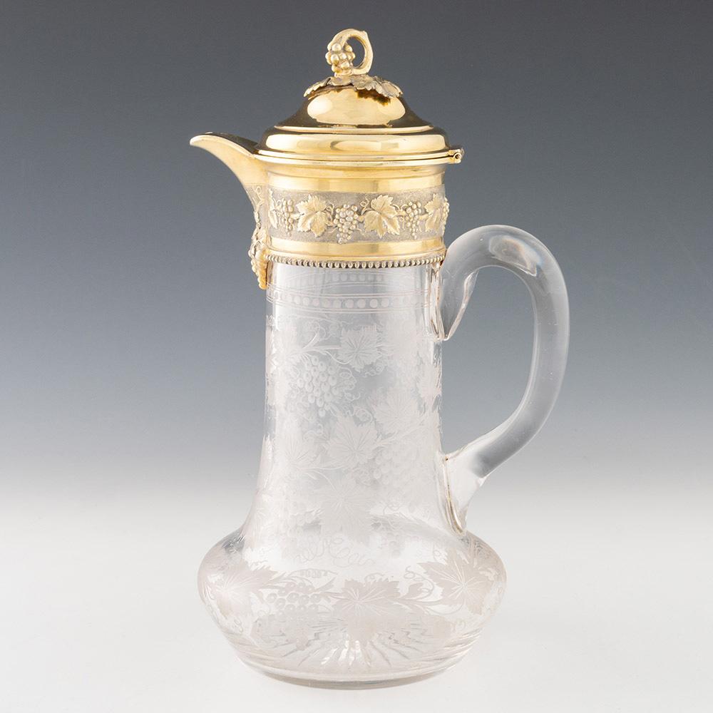 Heading : Silver Gilt Claret Jug by Garrard
Date : Hallmarked in 1882 For  R & S Garrard & Co (James Garrard)
Period : Victoria
Origin : London England
Decoration :Silver gilt cover.  Loop finial with grapes and vine leaves. The collar with high