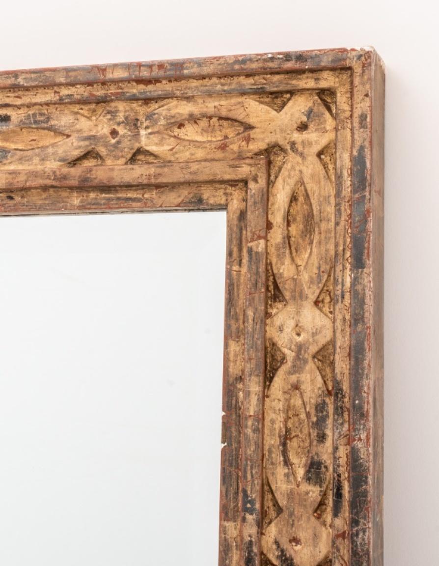 Silver gilded geometric patterned carved wooden frame, mounted with a central mirrored plate, rectangular with low relief elements. 

Dealer: S138XX.