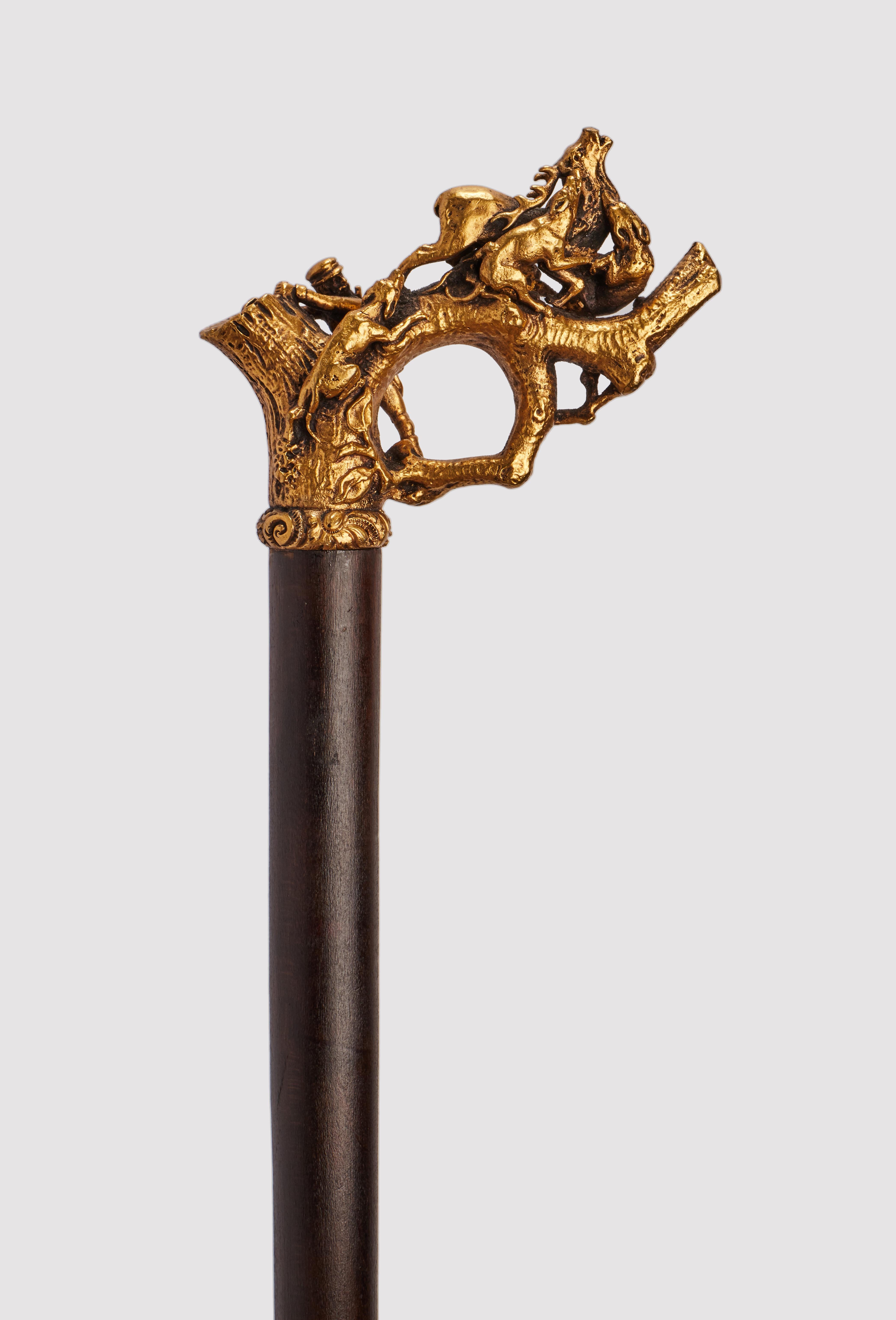 Walking stick: handle, made out of silver gilt representing an hunting scene, with hunter and dogs. Ebony wood shaft. Metal ferrule. Germany circa 1890.