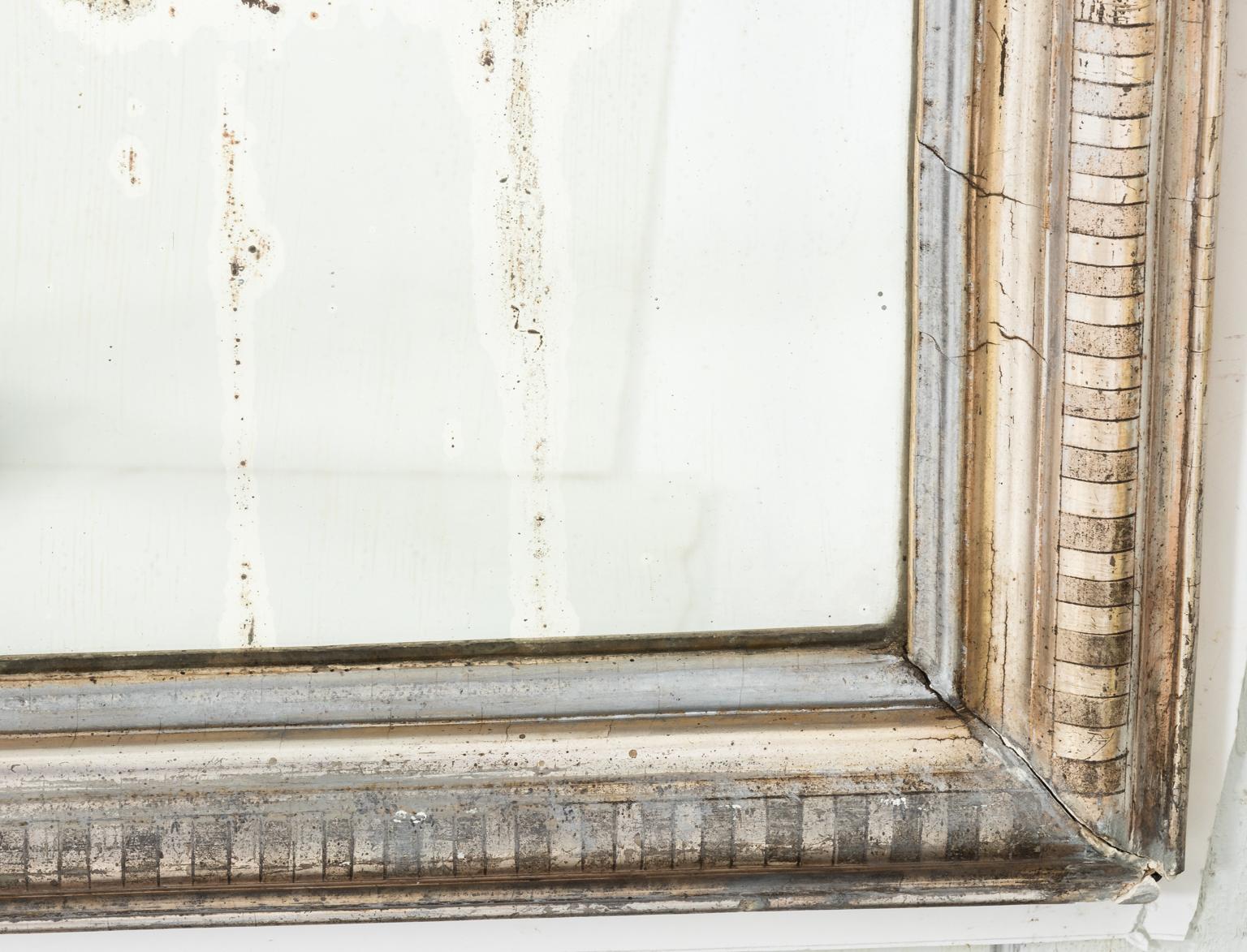 Louis Phillip mirror with silver gilt and original glass. Please note of wear to age to the mirror plate, circa 1850s. This piece weighs less than 40 LBS.
 
