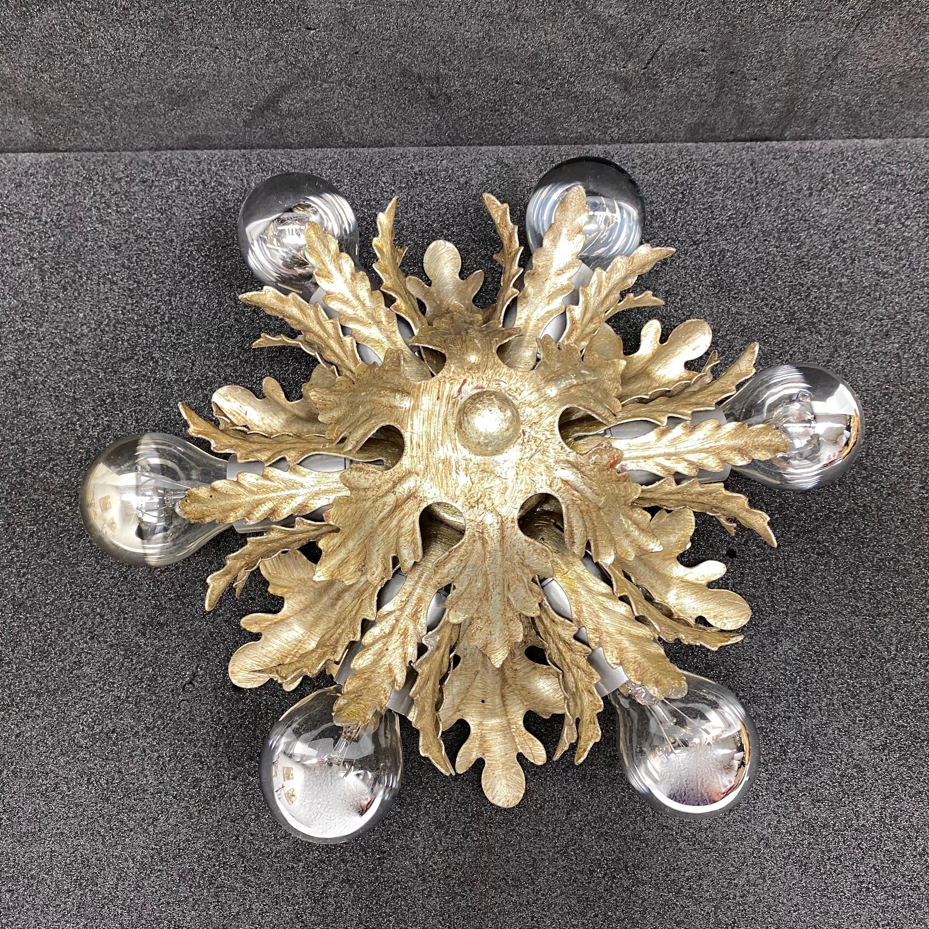 Add a touch of opulence to your home with this charming flush mount. Perfect silver gilt metal leafs to enhance any chic or eclectic home. We'd love to see it hanging in an entryway as a charming welcome home. Built in the 1960s, made by Koegl
