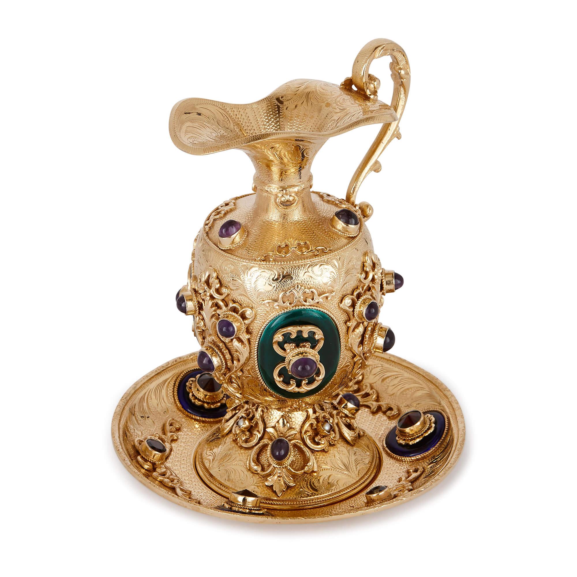 This miniature jug and basin was crafted at the beginning of the 20th century from a combination of silver-gilt, enamel and precious gemstones. 

The surface of the shallow basin is embossed with scrolling floral motifs and other, more abstract