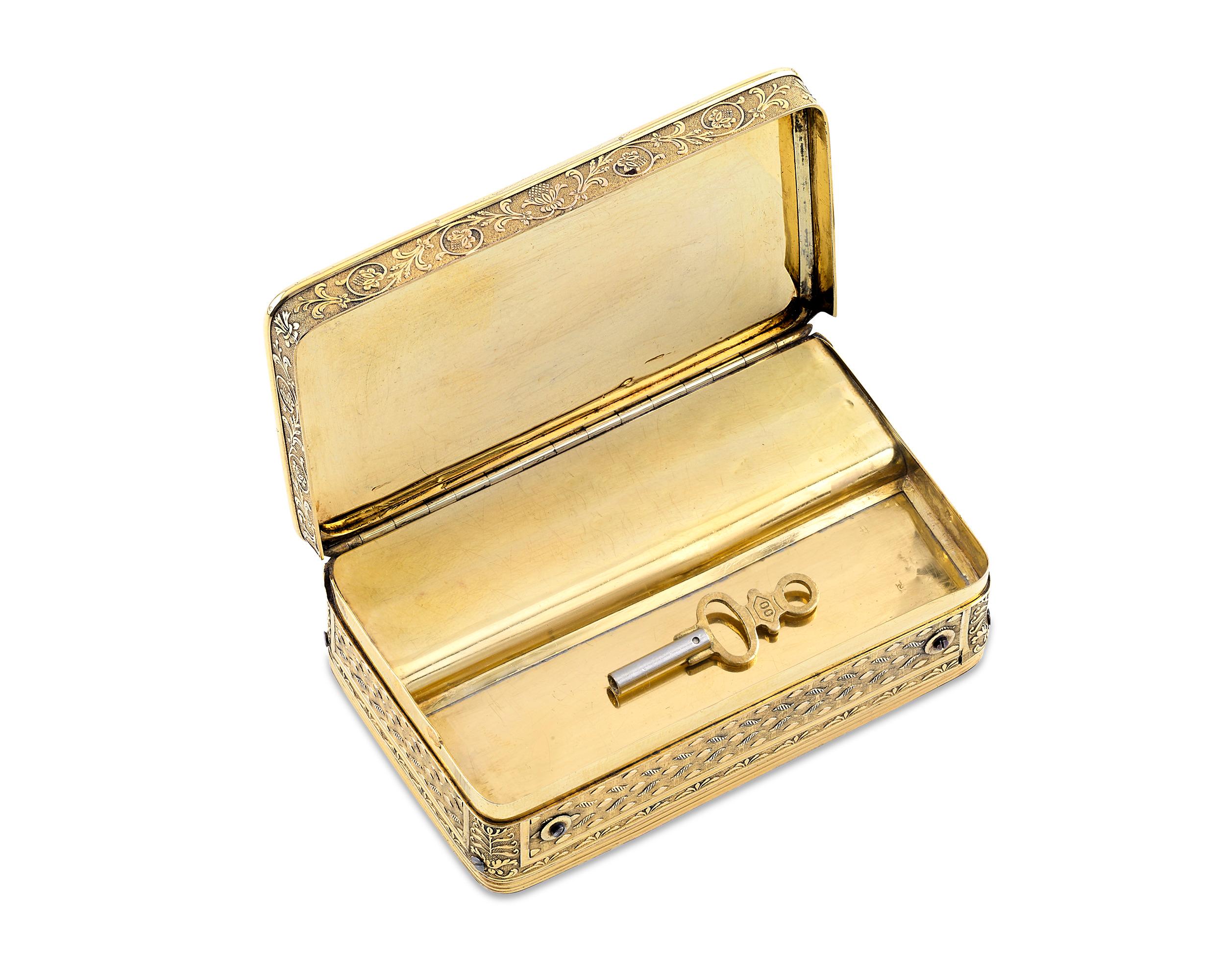This exceptional Swiss silver-gilt musical snuff box was crafted by the famed François Nicole. At first glance, the diminutive piece appears to simply be an exquisite 19th-century snuff box, with Neoclassical-style chased and engraved borders of