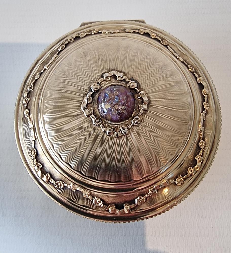 A silver gilt and jewelled pill box probably Austrian but with English import marks for London, 1905. Very fine quality with the silver gilt completely intact and mint within the box. The lid heavily engine turned with radii from the centre which