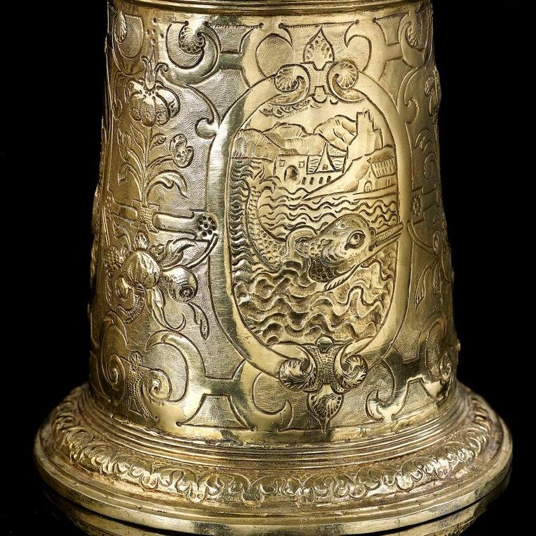 A silver gilt Renaissance tankard, German, unmarked circa 1600, original fire gilding, the small size of the tankard suggests it was made for a lady, it stands at 16 cm in height to the top of the final, which is surmounted by a hound and weighs