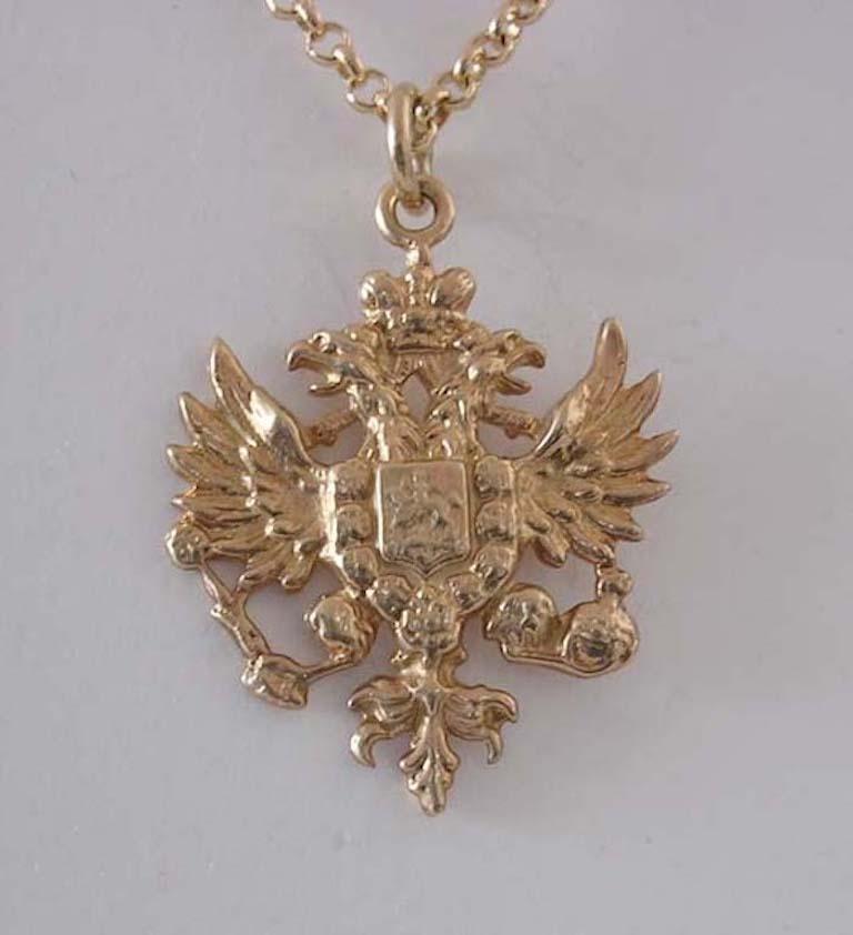 The Romanov double-headed eagle with outspread wings, its claws clutching orb and sceptre, surmounted by an imperial crown, the reverse smooth vermeil. Chain not included.

1 1/8 in. (2.9 cm.) long, including suspension ring; 3/4 in. (1.9 cm)