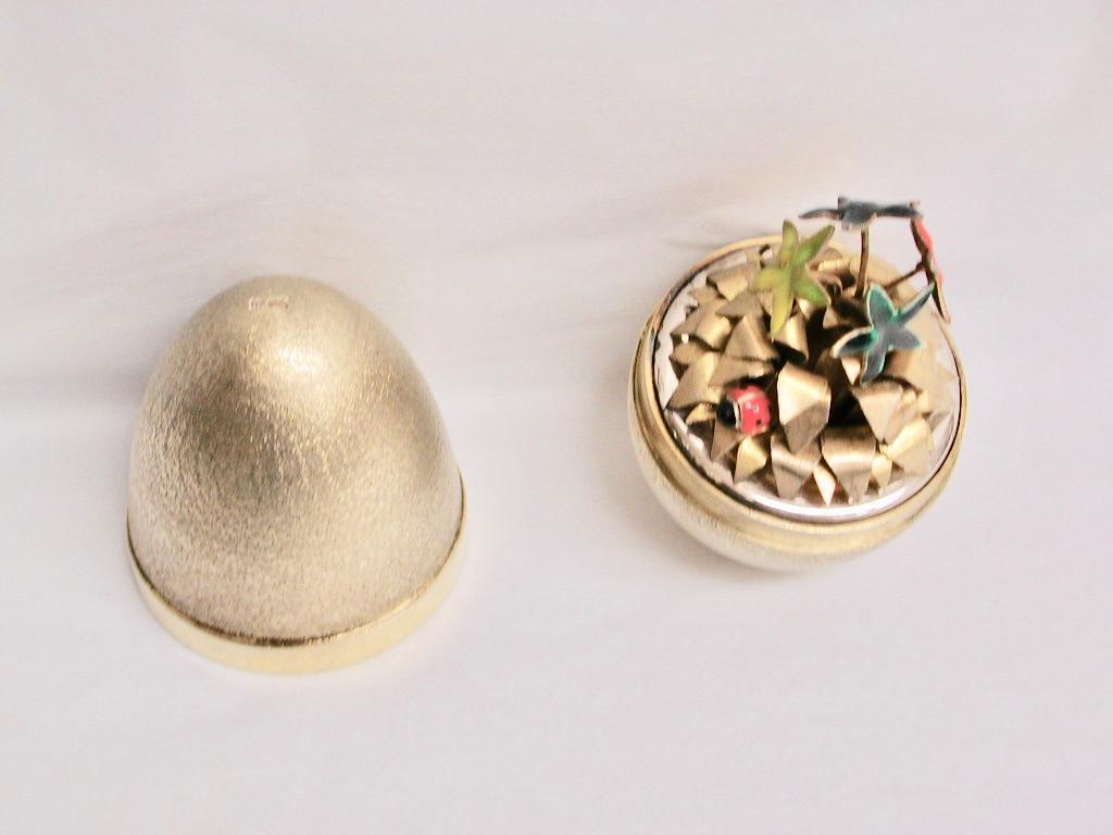 Silver gilt Stuart Devlin egg, dated 1976, London Assay
Textured in a matt finish with enamelled star shaped flowers and leafwork inside plus a single
ladybird.
Made in a thick heavy gauge of silver, no box
These eggs have been highly