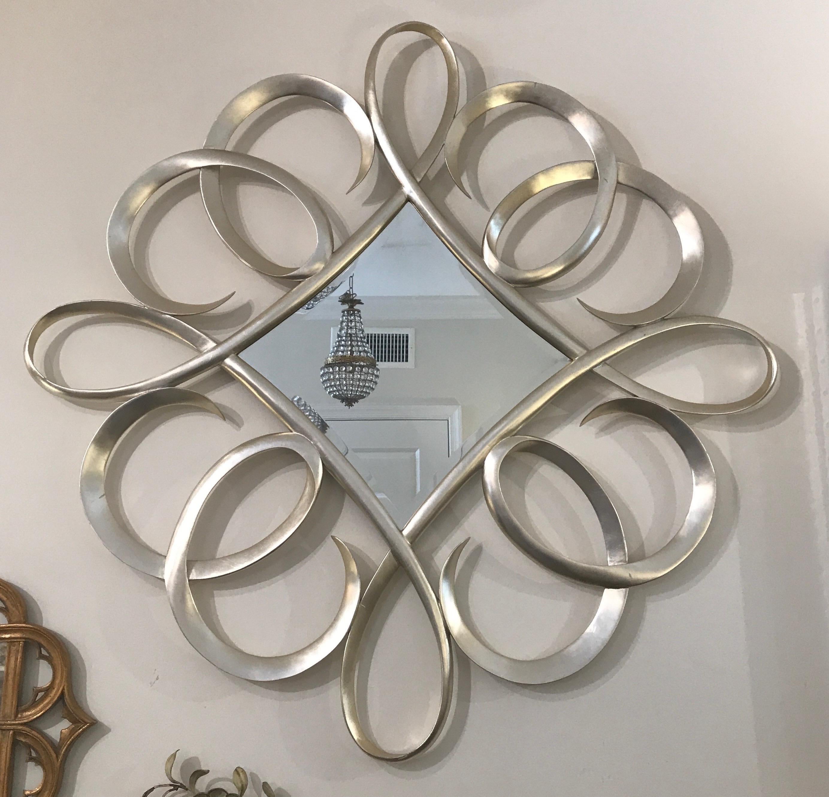 Carved & silver gilded swirled mirror by Christopher Guy.