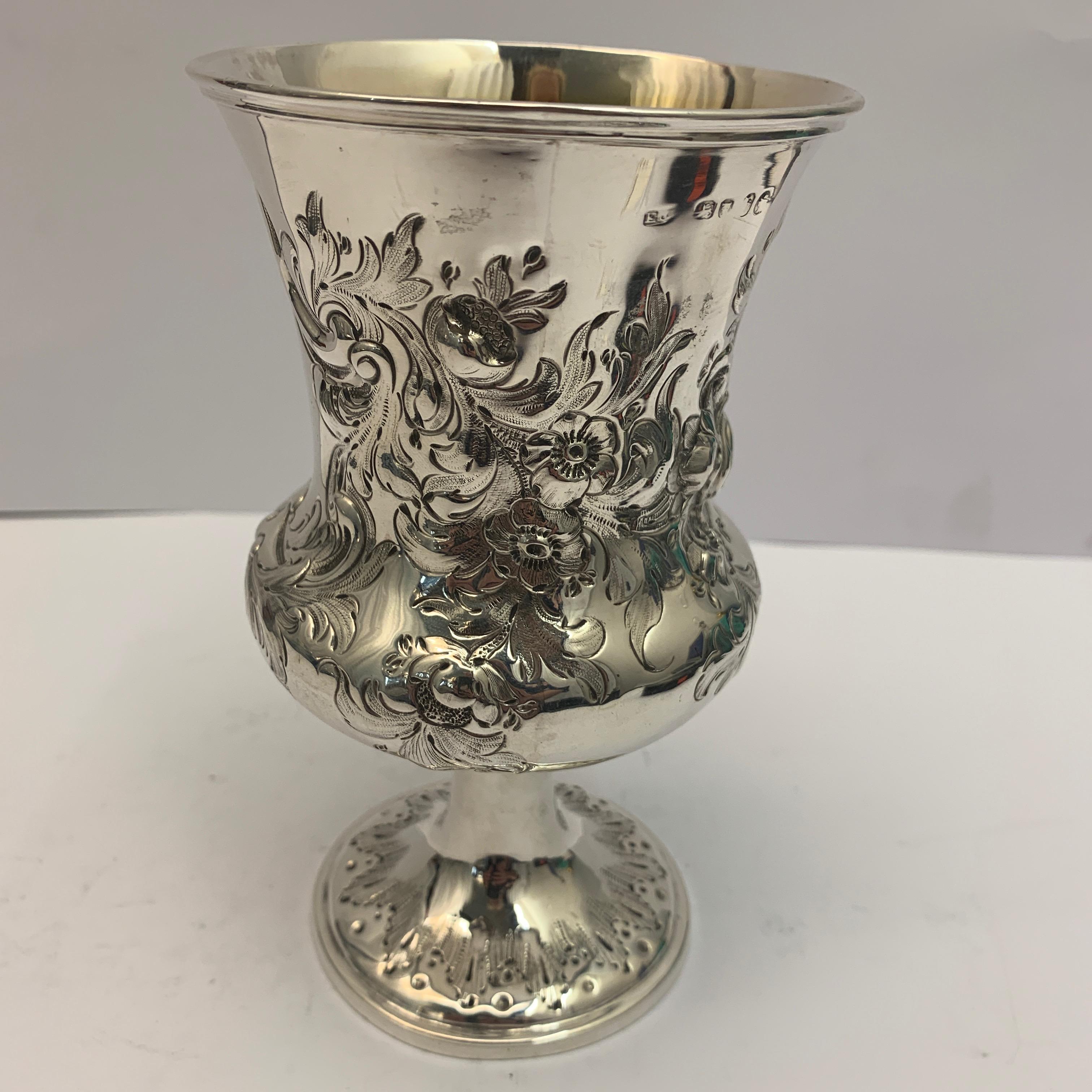 A silver goblet with gilt interior and decorated with flowers and leaves. Hallmarked for 1857.