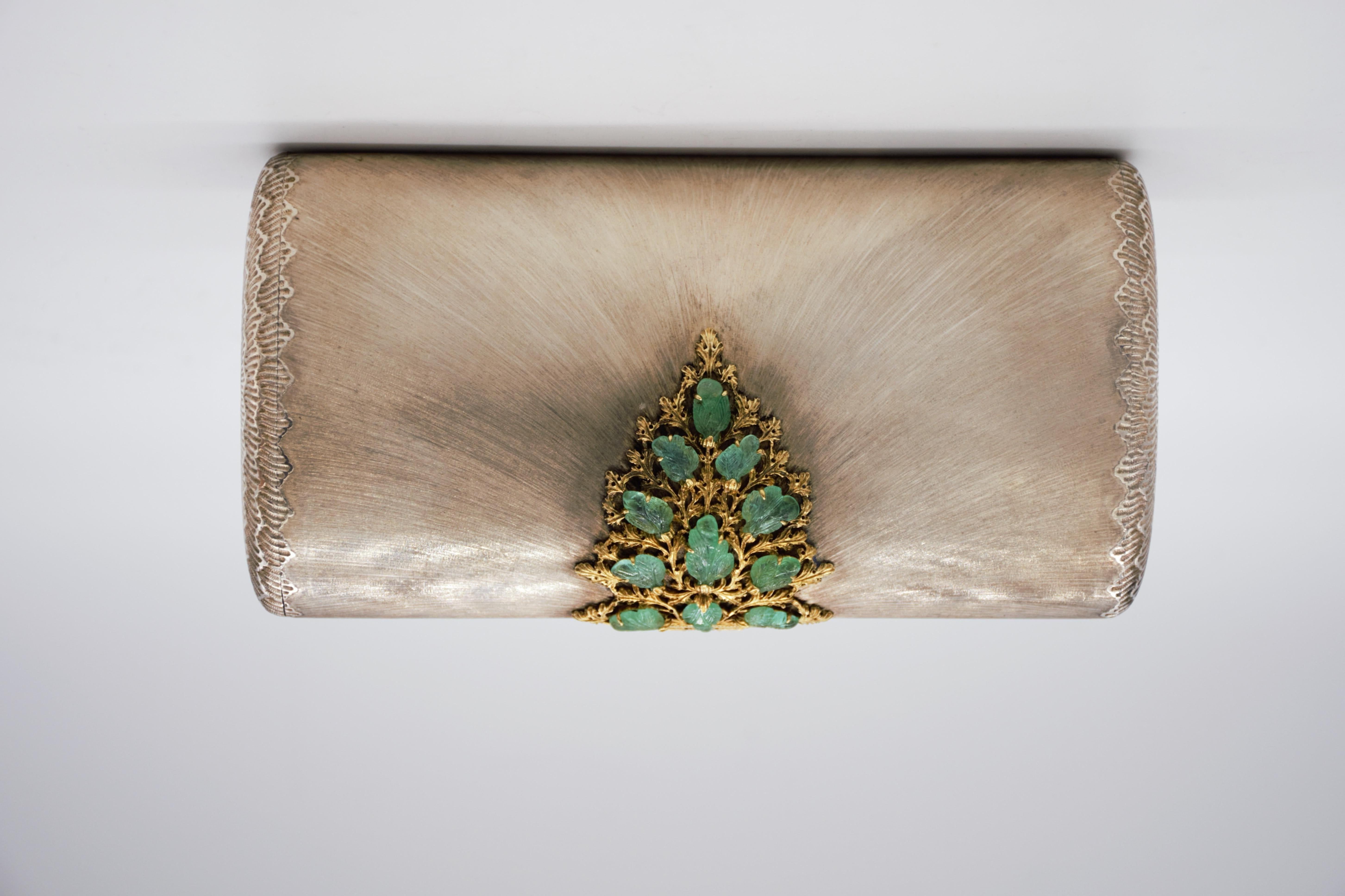 Rare and one of a kind important Mario Buccellati clutch.
Gold, silver and carved Emeralds evening bag, The silver bag engraved in a sunburst-like Pattern, the clasp set with 11 carved emeralds, carved as leaves , set on an 18 karat gold Clasp.
