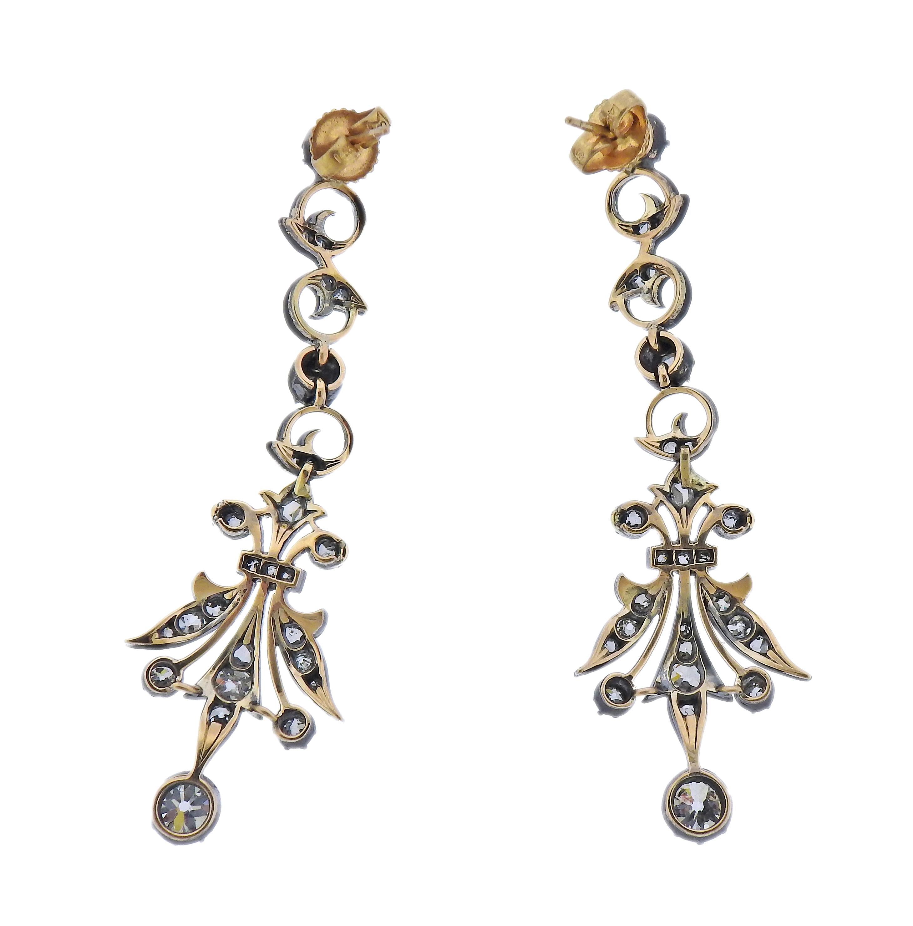 Pair of yellow gold (post and backs) silver drop earrings, with a combination of rose and old mine cut diamonds. Earrings are 57mm long. Weight - 10.2 grams. 